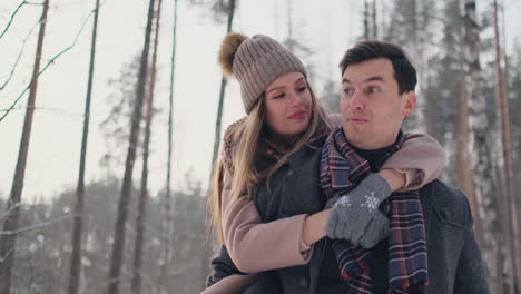 Young-Beautiful-Couple-Taking-Fun-and-Smiling-Outdoors-in-Snowy-Winter